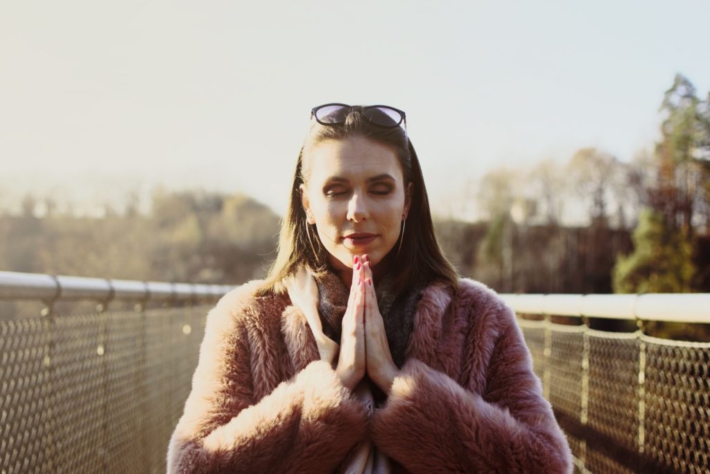 Woman seen practicing Gratitude as Self Love is a key to manifestation