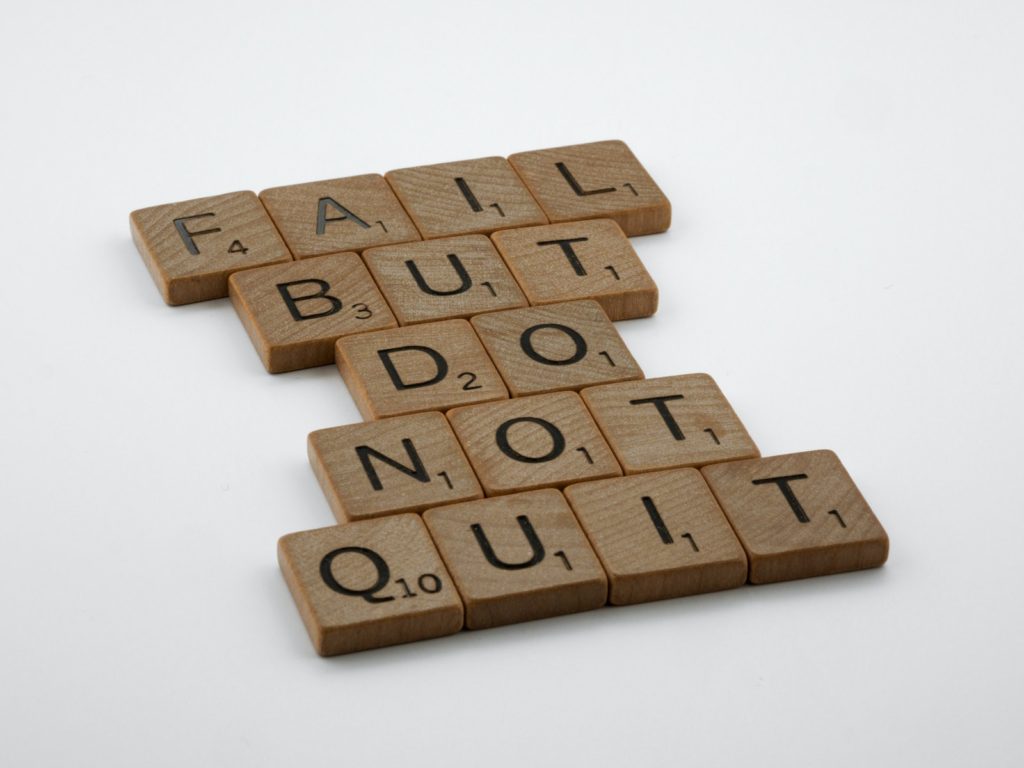 Brown Wooden Scrabble Tiles on White Surface